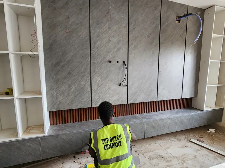 TV wall, shelving, and panel finishing in progress